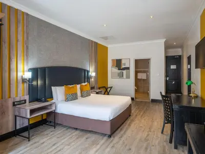 a hotel room with a bed and a desk at ANEW Hotel Highveld Emalahleni in Witbank