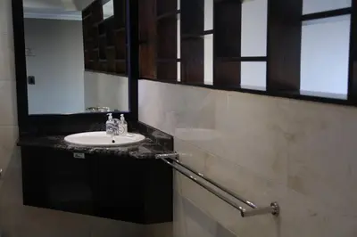 a bathroom with a sink and a mirror at Kosmos Lodge in Hartbeespoort