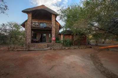 a small brick house with a stop sign in front of it at Wildgoose Lodge in Marloth Park