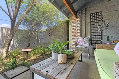 an outdoor patio with a wooden table and plants at Veranda House Boutique Accommodation in Midrand