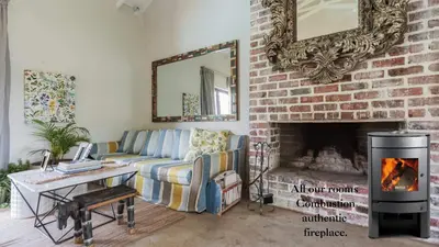 a living room with a couch and a fireplace at Veranda House Boutique Accommodation in Midrand