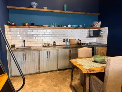 a kitchen with a table and a counter top at Veranda House Boutique Accommodation in Midrand