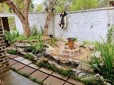 a garden with a fire hydrant and a wall at Veranda House Boutique Accommodation in Midrand