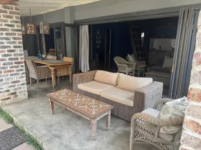 a patio with a couch and chairs and a table at Veranda House Boutique Accommodation in Midrand