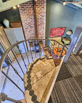 a room with a staircase with a couch and a table at Veranda House Boutique Accommodation in Midrand