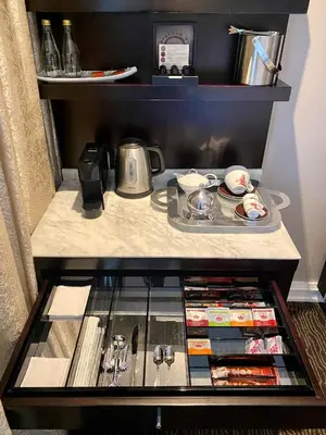 a small refrigerator with food and drinks on a shelf at InterContinental Johannesburg OR Tambo Airport Hotel by IHG in Kempton Park