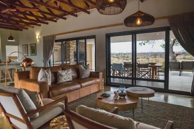 a living room with a couch and a table at MANZINI RIVER HOUSE - Mjejane Private Game Reserve, Greater Kruger National Park in Hectorspruit