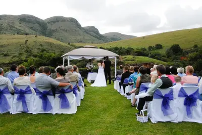 a wedding ceremony in a gazebo in the mountains at Nooitgedacht Trout Lodge in Lydenburg