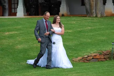 a man and a woman in a white wedding dress at Nooitgedacht Trout Lodge in Lydenburg