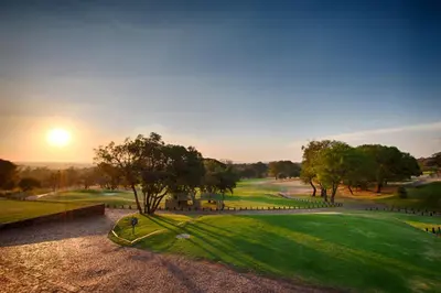 an aerial view of a golf course at sunset at Seasons Golf, Leisure, Spa in Hartbeespoort