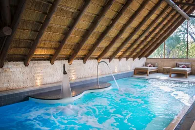 a swimming pool in the middle of a house at Seasons Golf, Leisure, Spa in Hartbeespoort