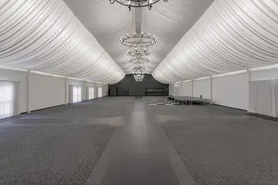 a large room with a large white ceiling with chandeliers at Protea Hotel by Marriott Polokwane Ranch Resort in Polokwane