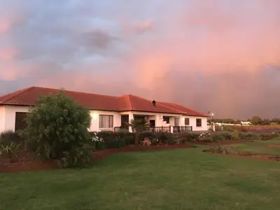 a rainbow in the sky over a house at Bottom of Boden in Benoni