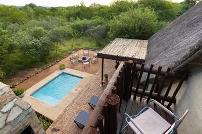 an overhead view of a swimming pool on a balcony at Zebra Lodge in Hoedspruit
