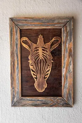 a picture of a zebra head in a wooden frame at Zebra Lodge in Hoedspruit