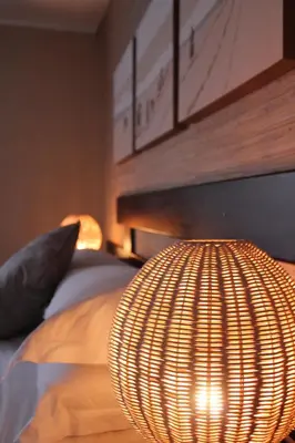 a large orb light in front of a bed at Mosate Lodge in Polokwane