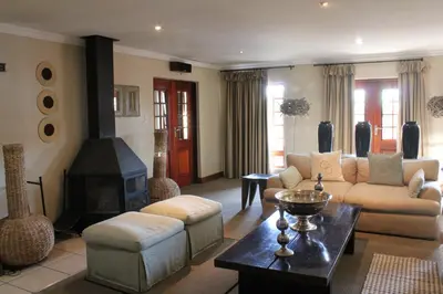 a living room with a couch and a fireplace at Mosate Lodge in Polokwane