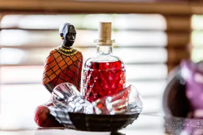 a glass bottle of red potion in a bowl at Beetleloop Guest House in Nelspruit