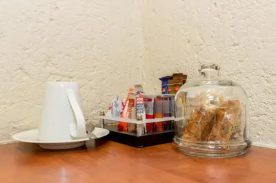 a table with a jar of pastries and a candle at Beetleloop Guest House in Nelspruit