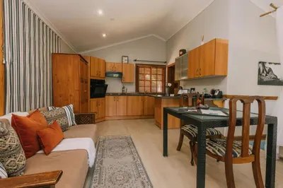 a living room with a couch and a table at Beetleloop Guest House in Nelspruit