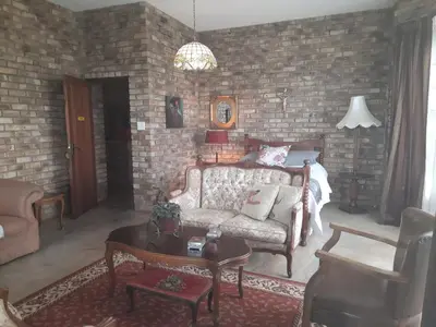 a living room with a couch and a brick wall at MyAula in Tierpoort