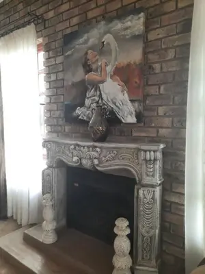 a painting of two women sitting on a fireplace at MyAula in Tierpoort