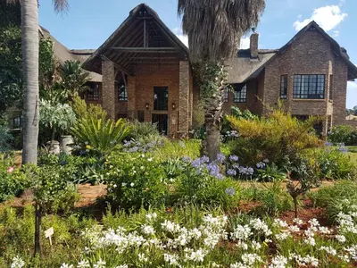 a garden in front of a house with flowers at MyAula in Tierpoort