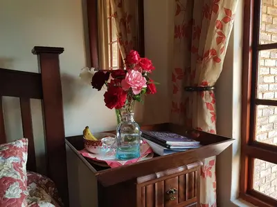 a table with a vase of flowers on it at MyAula in Tierpoort