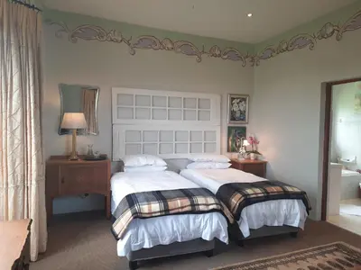 a bedroom with two beds with white sheets at MyAula in Tierpoort