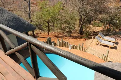 a view of a pool from the deck of a house at Lions Place in Grietjie Nature Reserve