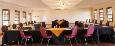 a conference room with tables and chairs in it at Coach House Hotel & Spa Tzaneen in Tzaneen