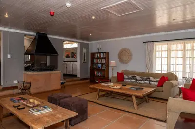 a living room with a couch and a table at Chestnut Country Lodge in Hazyview