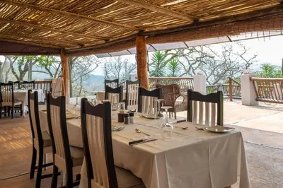 a table set up for a meal at a restaurant at Chestnut Country Lodge in Hazyview