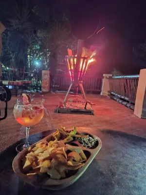 a plate of food on a table with a drink at Chestnut Country Lodge in Hazyview