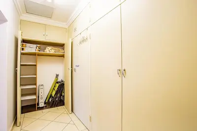 a walk in closet with a glass door at LeoZet Self catering apartment in Pretoria