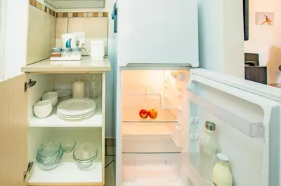 a refrigerator with its door open with food inside at LeoZet Self catering apartment in Pretoria