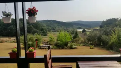 a view of a patio with a view of a yard at Woodcutters Guest House in Haenertsburg