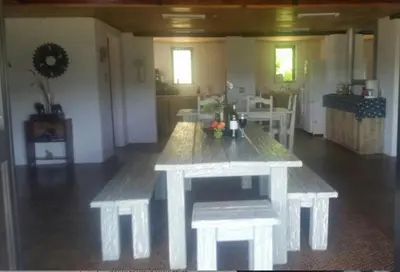 a large white table in a living room at Woodcutters Guest House in Haenertsburg