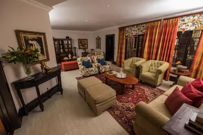 a living room with a couch and chairs and a table at Ivory Manor Boutique Hotel in Pretoria