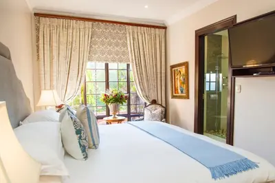 a bedroom with a large white bed and a window at Ivory Manor Boutique Hotel in Pretoria