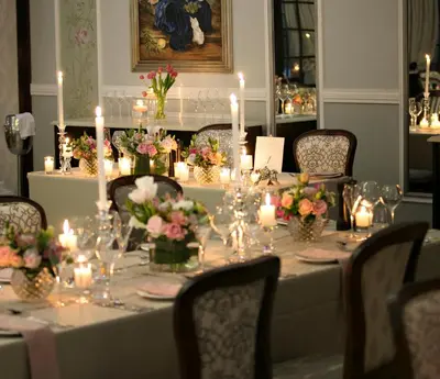 a long table with candles and flowers on it at Ivory Manor Boutique Hotel in Pretoria