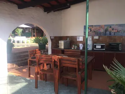 a restaurant with a table and chairs and a counter at Villa Grande Lodge in Louis Trichardt