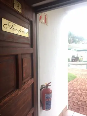 a fire hydrant sitting on the side of a door at Villa Grande Lodge in Louis Trichardt