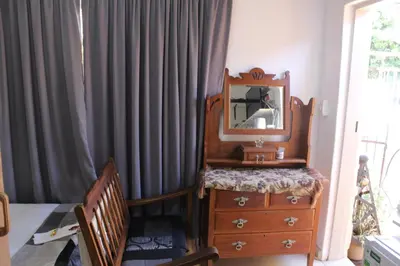 a room with a dresser and a mirror on a dresser at Grace Accommodation Centurion in Centurion
