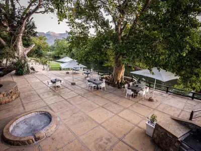 an overhead view of a patio with tables and umbrellas at Moholoholo Ya Mati in Kampersrus AH