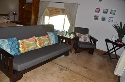 a living room with a couch and a chair at Moholoholo Ya Mati in Kampersrus AH