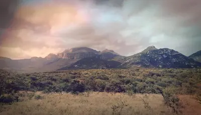 a view of a mountain in the middle of a field at Moholoholo Mountain View in Hoedspruit