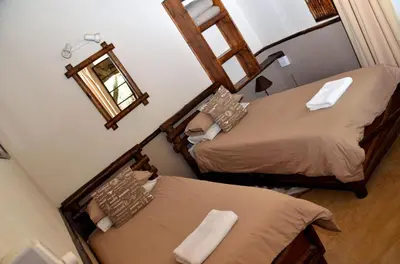 an overhead view of a bedroom with two beds and a mirror at Moholoholo Mountain View in Hoedspruit