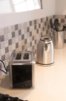 a toaster sitting on top of a kitchen counter at 3 Lux Suites in Middelburg