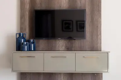 a white cabinet with a television on top of it at 3 Lux Suites in Middelburg